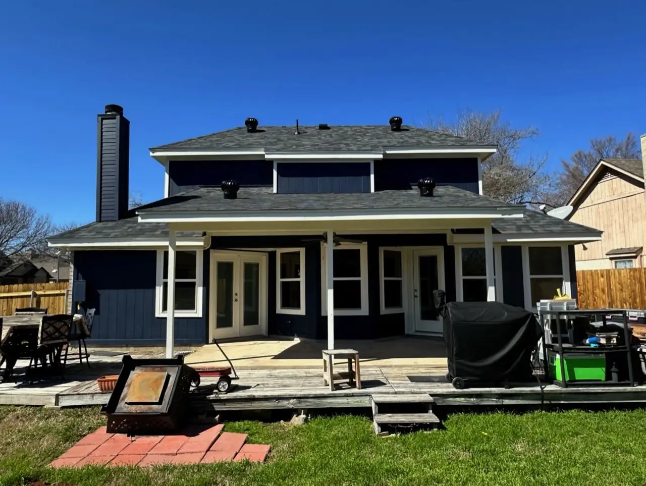 The same Austin two-story after Tex Painting repainted it navy blue