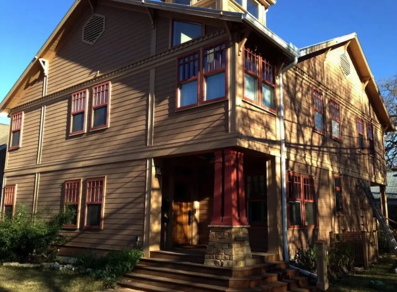 Brown craftsman exterior with red trim before repainting