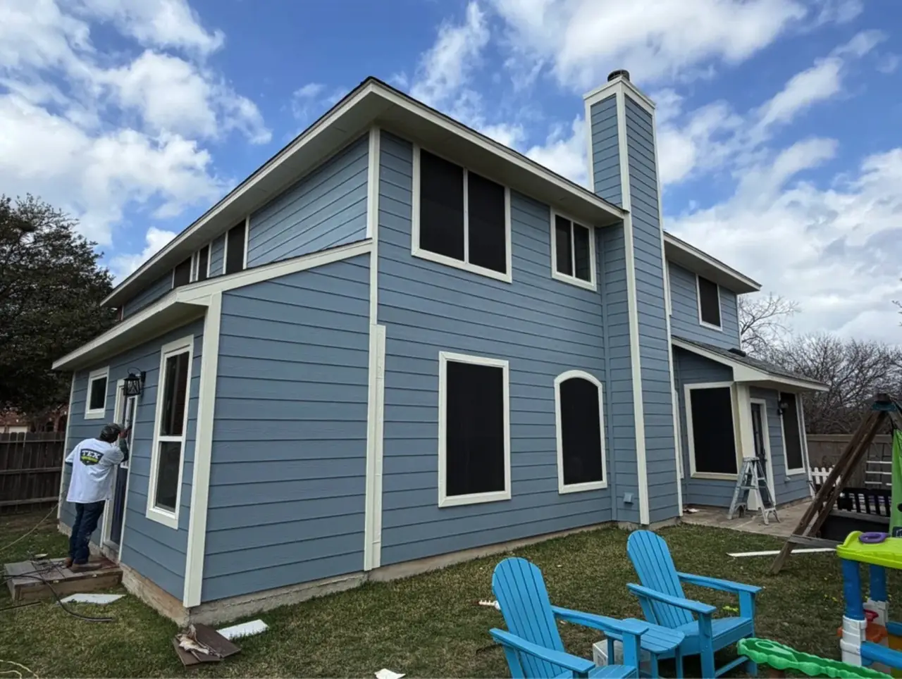 The same home after repainting in light blue with cream trim