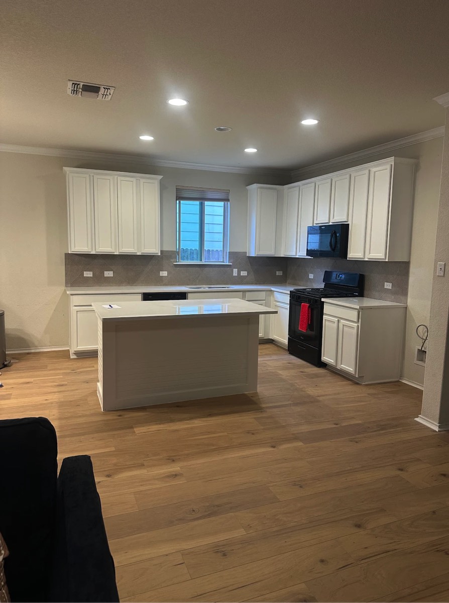 Kitchen cabinets and island finished in white